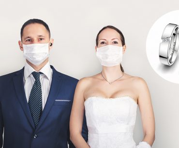 married couple with masks standing next to rings